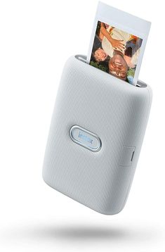 an electronic device with a photo attached to it's back side and two photos in the holder