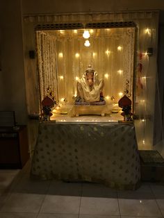 a man sitting on top of a table in front of a stage covered with lights