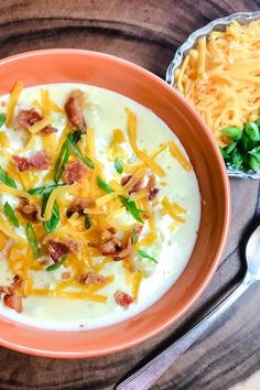 a bowl of soup with cheese and bacon on top