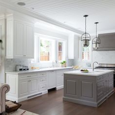 a living room filled with furniture next to a kitchen and breakfast nook on top of a hard wood floor