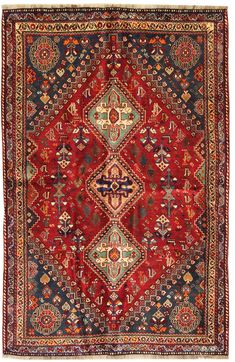 an antique persian rug with red and blue colors