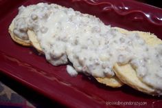 a red plate topped with food covered in gravy