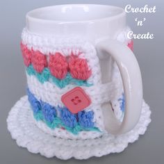 a crocheted coffee cup and saucer on a plate