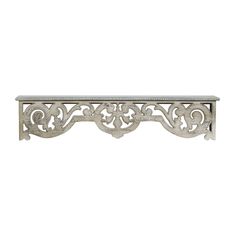 a metal shelf with an ornate design on the top and bottom, against a white background