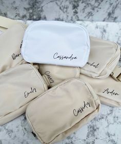 four personalized toiletries sitting on top of a marble counter