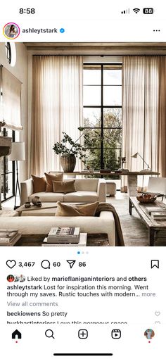 an instagramted photo of a living room with white furniture and large windows in the background