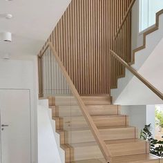 the stairs are made of wood and have glass balconies