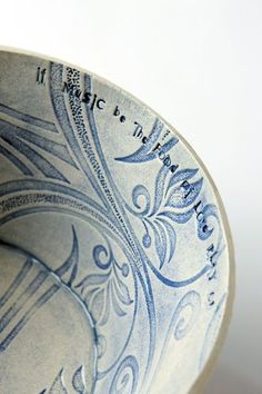 a close up view of a blue and white plate with writing on the side,