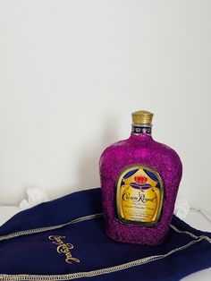 a purple bottle sitting on top of a blue bag