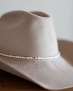 The perfect addition to any hat, our beaded hat bands feature a variety of semi-precious gemstones with leather ties for an adjustable closure to fit any hat. Dimensions: 21" beaded length before leather ties Material: Various Stones/Beads, Leather Cording Hardware: Gold Plated Jump Rings and Crimp Beads Closure: Leather Ties - brown for all stone options except pyrite, which uses black Stone Options: African TurquoiseTurquoiseLabradoritePyriteWhite HowlitePicasso JasperAqua Terra Jasper Handmad Western Style Adjustable Beaded Jewelry, Adjustable Beaded Fedora Hat Band, Adjustable Beaded Hat Bands, Classic Adjustable Gemstone Beads Jewelry, Adjustable Bead Cap Hat Bands For Festival, Adjustable Hat Band With Bead Caps For Festival, Adjustable Beaded Hat Bands For Rodeo, Classic Handmade Adjustable Hat Bands, Elegant Handmade Hat Bands For Rodeo