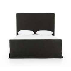 the bed has two pillows on it and is made in black fabric with white sheets