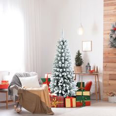 a living room with a christmas tree and presents