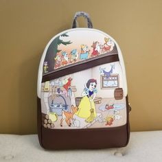 Snow White Has All The Help She Needs With Her Woodland Animals And Her 7 Dwarfs. Grab This Pretty Bag And Fill It With All Your On The Go Needs. Make This The Perfect Gift For That Special Someone... Or Just Treat Yourself! * * * * Features * * * * * Height 11.5" * Width 4.5" * Length 9" * Top Handle 3" * Padded Adjustable Straps * Zip Closure * Gold Hardware * Soft Faux Leather Exterior ... Raised Patterns * 1 Front Zip Pocket * Interior Is 7 Dwarfs And Flower Print Fabric * Inside Has 1 Zip P Snow White 7 Dwarfs, Mermaid Backpack, Flower Print Fabric, Mickey Mouse Backpack, Snow White Seven Dwarfs, Animal Backpacks, 7 Dwarfs, Disney Snow White, Loungefly Bag