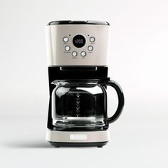 a white and black coffee maker sitting on top of a counter