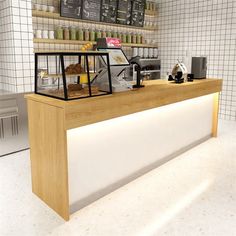 a counter in a coffee shop with lots of items on the shelves and behind it is a white tiled wall