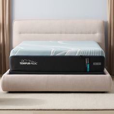 the tempur - pec mattress is sitting on top of a bed frame