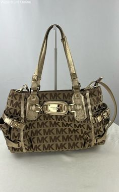 Michael Kors Crossbody Brand: Michael Kors Style: Crossbody Condition: New with tags Purse Closure: Zipper Exterior Color: Tan Exterior Material: Canvas Approximate Measurements (inches): 14L x 9W x 5H Additional Details Lining Color: Beige Handle/Strap Color: Gold Pattern: Monogram Hardware Color: Gold Size: Large Lining Material: Fabric *Please fully inspect the listing's photographs, item specifics, and description.    *Have questions? Ask away, and we will respond as soon as possible! We are always happy to provide additional information and photos.    *Change your mind? You can return your item within 30 days for your money back.   *We ship using USPS Ground Advantage, USPS Priority Mail, and UPS Ground. Shipping options are selected for each listing based on the size and weight of th Trendy Michael Kors Shoulder Bag With Gold-tone Hardware, Classic Michael Kors Shoulder Bag With Gold-tone Hardware, Logo Beige, Michael Kors Shoulder Bag With Gold-tone Hardware For Travel, Michael Kors Bags With Gold-tone Hardware For On-the-go, Michael Kors Fashion, Michael Kors Brown Bags With Gold-tone Hardware, Michael Kors Crossbody, Gold Accent