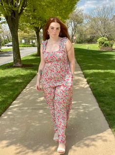 This wide-leg jumpsuit is so soft and pretty. It's the perfect one and done to dress down or up. The floral pattern and colors are gorg. Features wide ruffled straps, flowy wide-leg pants, back cutout with elastic, tie-back detail, and pockets. Fully lined.The model is 5' 9" 33-25.5-36 - Size S Floral Print Non-stretch Wide Leg Jeans, Summer Jumpsuit With Floral Print And V-neck, Pink Floral Print V-neck Jumpsuit, Flowy Wide Leg Pants, Pink Floral Print V-neck Jumpsuit/romper, One And Done, Multicolor Floral Print V-neck Sleepwear, Floral Jumpsuit, Wide Leg Jumpsuit