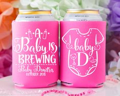 two pink can coolers with baby's brewing on the front and bottom, sitting next to each other