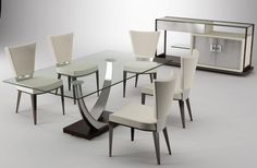 a glass dining table with white chairs around it