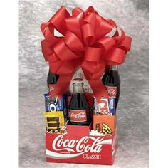 Nostalgia runs wild in the Coke Pack gift basket. The snacks America has loved for generations will take your special someone back to a simpler place and time. Classic Coke, childhood chocolate favorites, popcorn and Wrigley's gum will make you feel like a kid again. Make the day special with the Coke Pack gift basket. The Old Time Coke Gift Pack.Old Time Coke Pack - Small. Includes: 3 Classic Cokes Peanut M& M's Reese's Peanut Butter Cups Oreo Cookies Nestle Crunch Ba Cracker Jacks Microwave Popcorn Luden's Cherry Throat & Cough Drops Wrigley's GumSpecifications Size: Small Weight: 4 lbs - SKU: GFT338 Color: Multicolor. Coca Cola Gifts, Coke Gifts, Snack Gift Baskets, Snack Gift, Teenager Gifts, Creative Diy Gifts, Aromatherapy Gifts, Reeses Peanut Butter Cups, Candy Bouquet