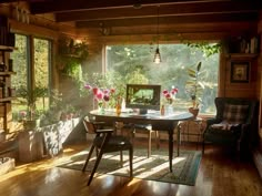 a dining room table and chairs in front of a large window with sunlight streaming through it