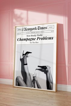 a poster on the floor in front of a pink wall with an advertisement for champagne problems