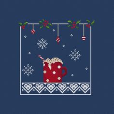 a cross stitch christmas sweater with a mug