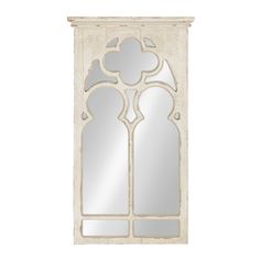 a mirror that is sitting on top of a wall with an arched window in the middle