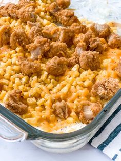 a casserole dish filled with macaroni and cheese covered in ground meat