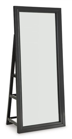 a black framed mirror sitting on top of a white floor next to a wooden frame