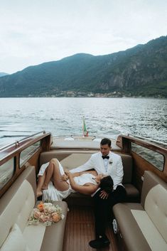 a man and woman sitting on the back of a boat