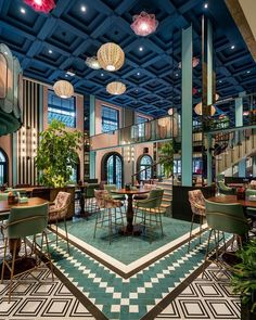 the interior of a restaurant with tables and chairs