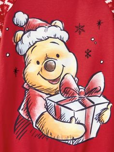 a red shirt with a cartoon bear holding a present