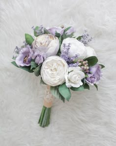 a bridal bouquet with white and purple flowers