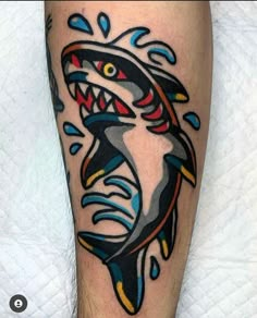 a man with a shark tattoo on his leg