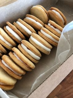 a box filled with lots of cookies covered in frosting