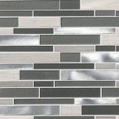 a gray and white tile backsplash with silver foil on the edges, in an irregular pattern