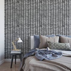 a bedroom with black and white patterned wallpaper