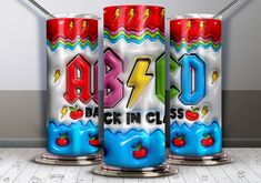 three colorful cans with the word abcd on them