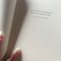 a person holding an open book with a quote on it