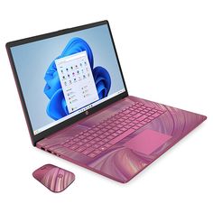 an open laptop computer sitting on top of a pink mouse next to it's keyboard