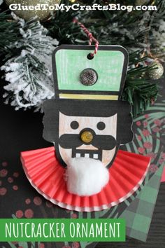 a nutcracker ornament hanging from a christmas tree with the text, how to make a nutcracker ornament