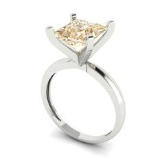 a white gold ring with a yellow diamond in the center, on a white background