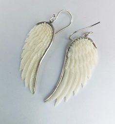 "Very detail crafted bone angel wing bezel with sterling silver and hang on earring hook earrings. Total length: 50mm (2 inch) Feather dimension: 40mm x 15mm (1 1/2\" x 5/8\" All items are lead and nickel free, they are sterling silver, not silver plated or silver filled." Carved Sterling Silver Earrings, White Wing-shaped Earrings For Gift, White Sterling Silver Jewelry With French Hook, Earring Hook, Wing Earrings, Hook Earrings, Angel Wings, Sterling Silver Earrings, Silver Earrings