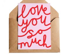 a greeting card with the words love you so much on it in red ink against a pink background