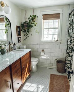 a bathroom with white tile and wooden cabinets