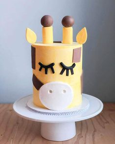 a cake decorated to look like a giraffe's head with eyes and ears