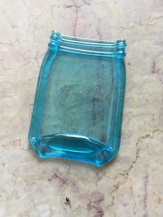 a blue glass dish sitting on top of a marble counter