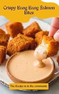 a person dipping some food into a small bowl on a white plate with the words crispy egg sauce bites above it